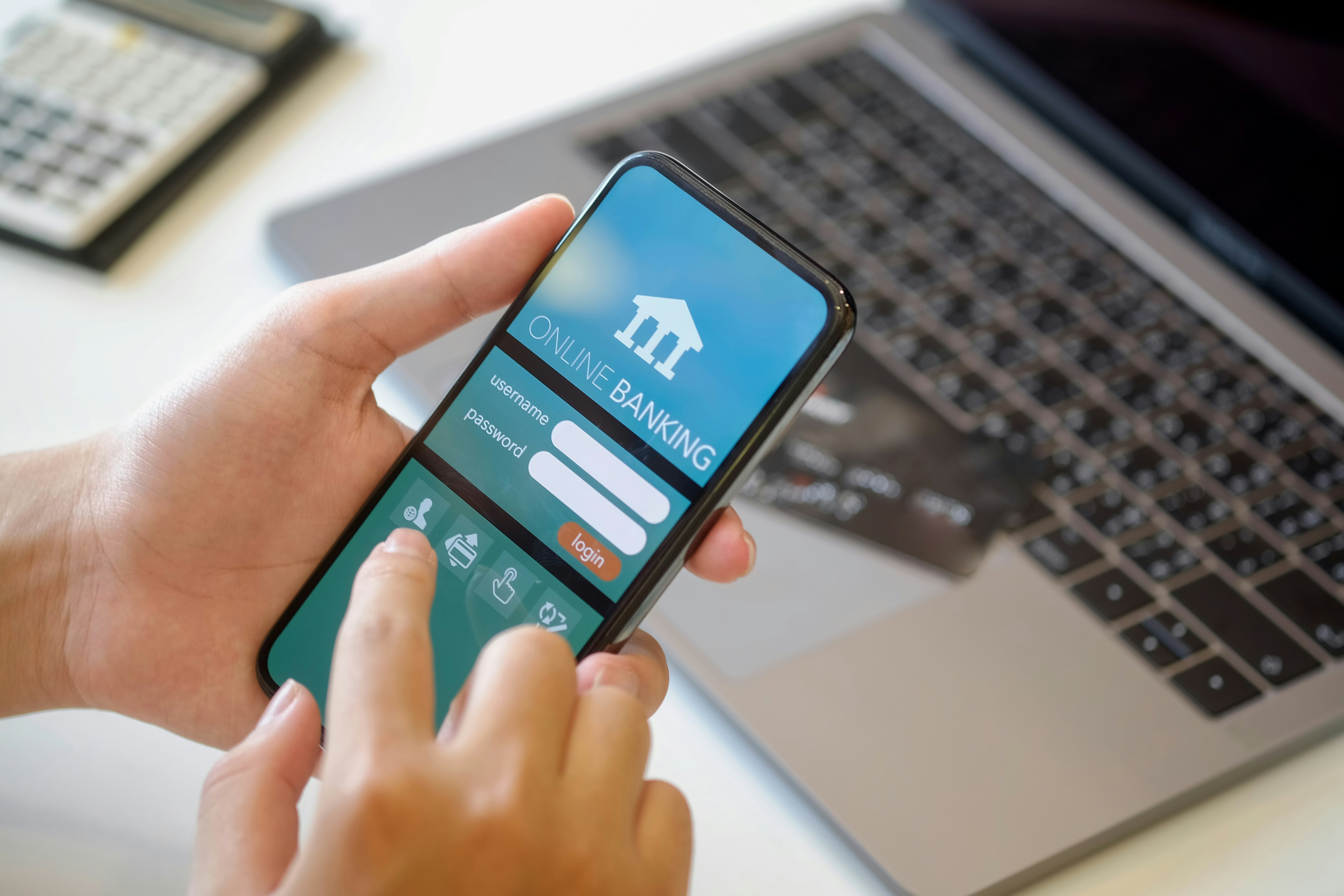A person holding phone showing digital banking